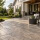 Stamped decorative concrete patio with outdoor seating and garden beds