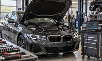 European sedan with its hood open beside diagnostic equipment in a workshop