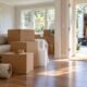 Packed moving boxes and a moving truck outside a home