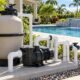 Pool pump and filtration equipment beside a residential swimming pool