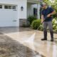 Professional pressure washing a residential concrete driveway